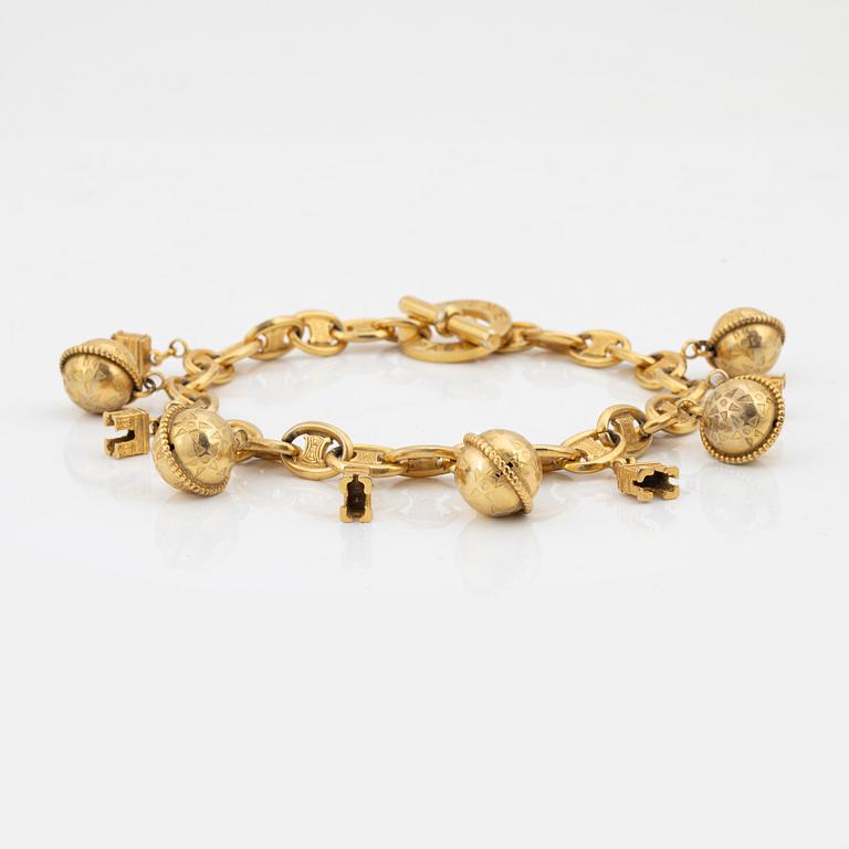 Céline, A gold tone charm necklace.