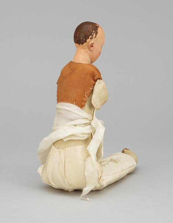 A 19th century wooden doll.