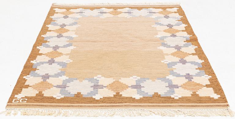 A flat weave rug, signed GG, c. 235 x 170 cm.