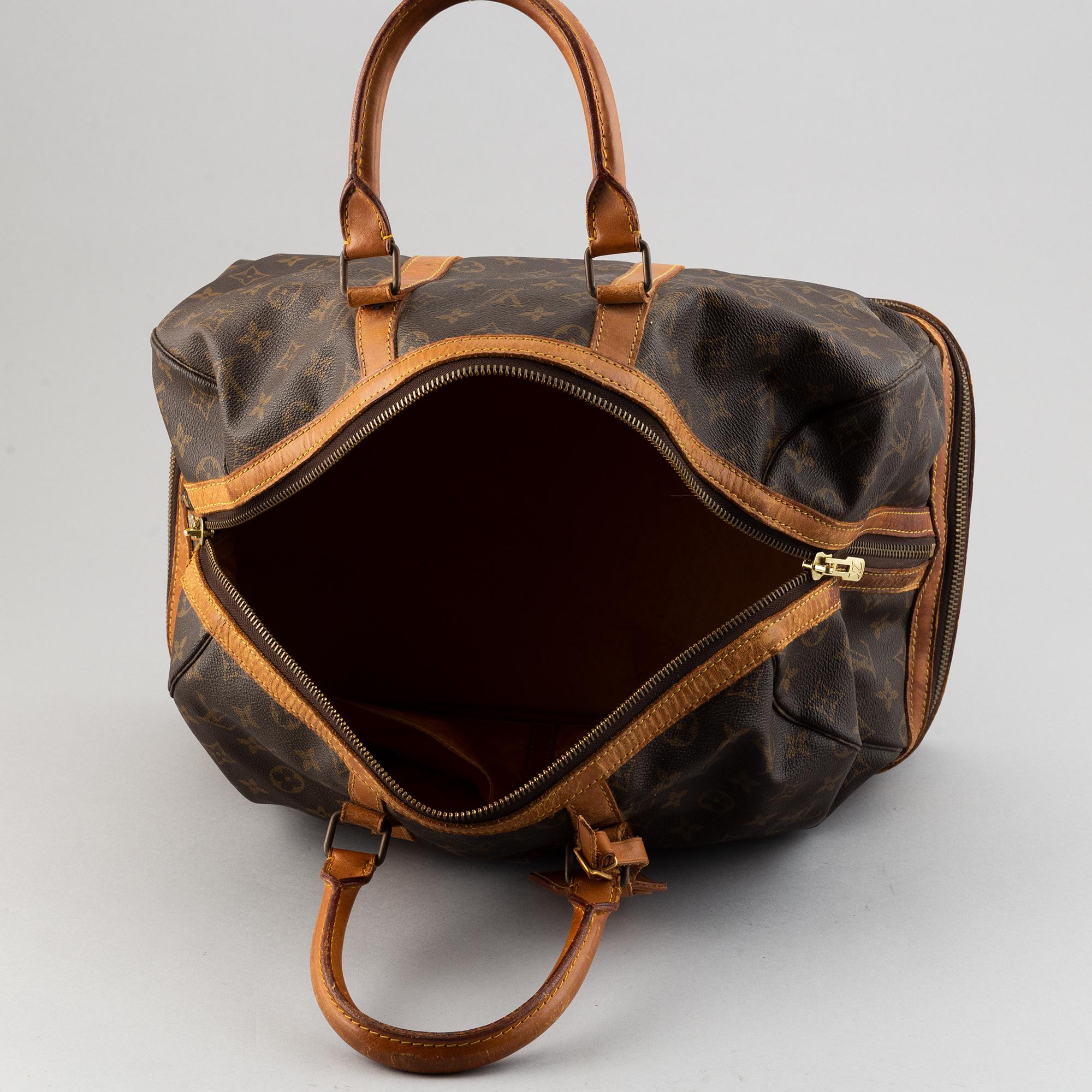 Louis Vuitton, a monogram canvas weekend bag.