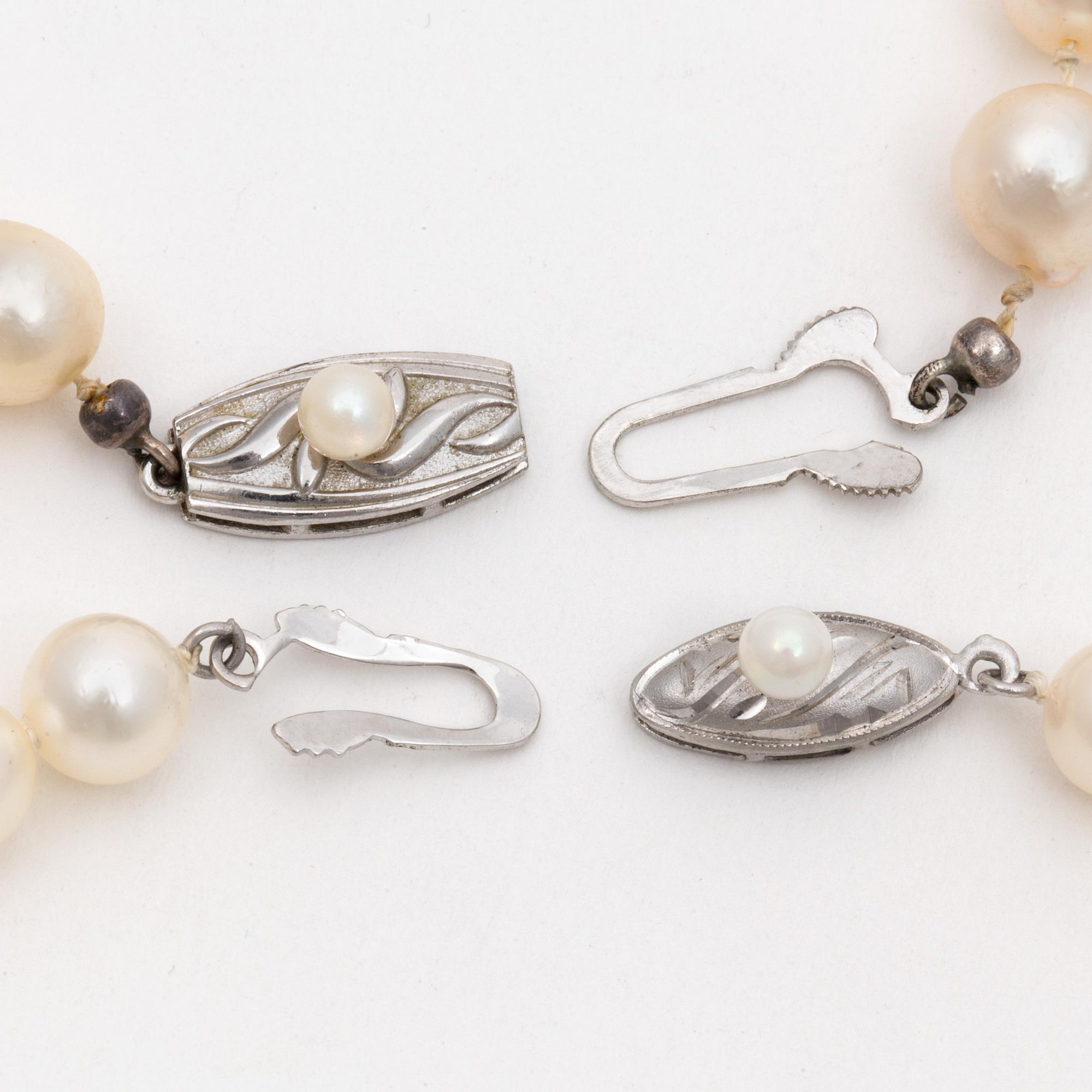 Two cultured pearl necklaces with silver clasps.