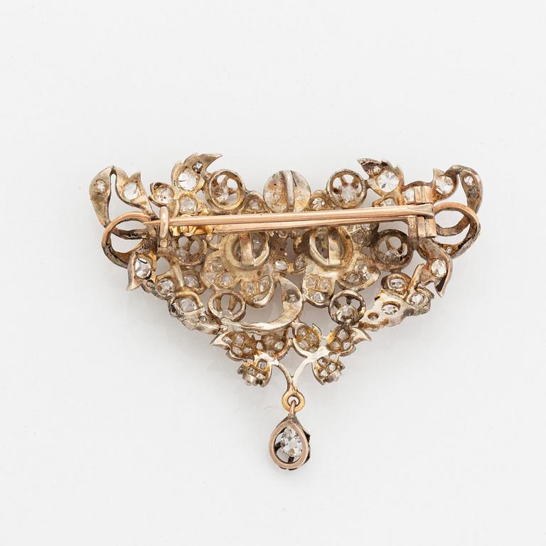 A silver brooch set with old-cut diamonds.