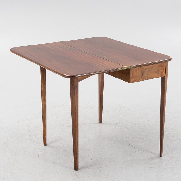 A mahogany games table, early 19th Century.