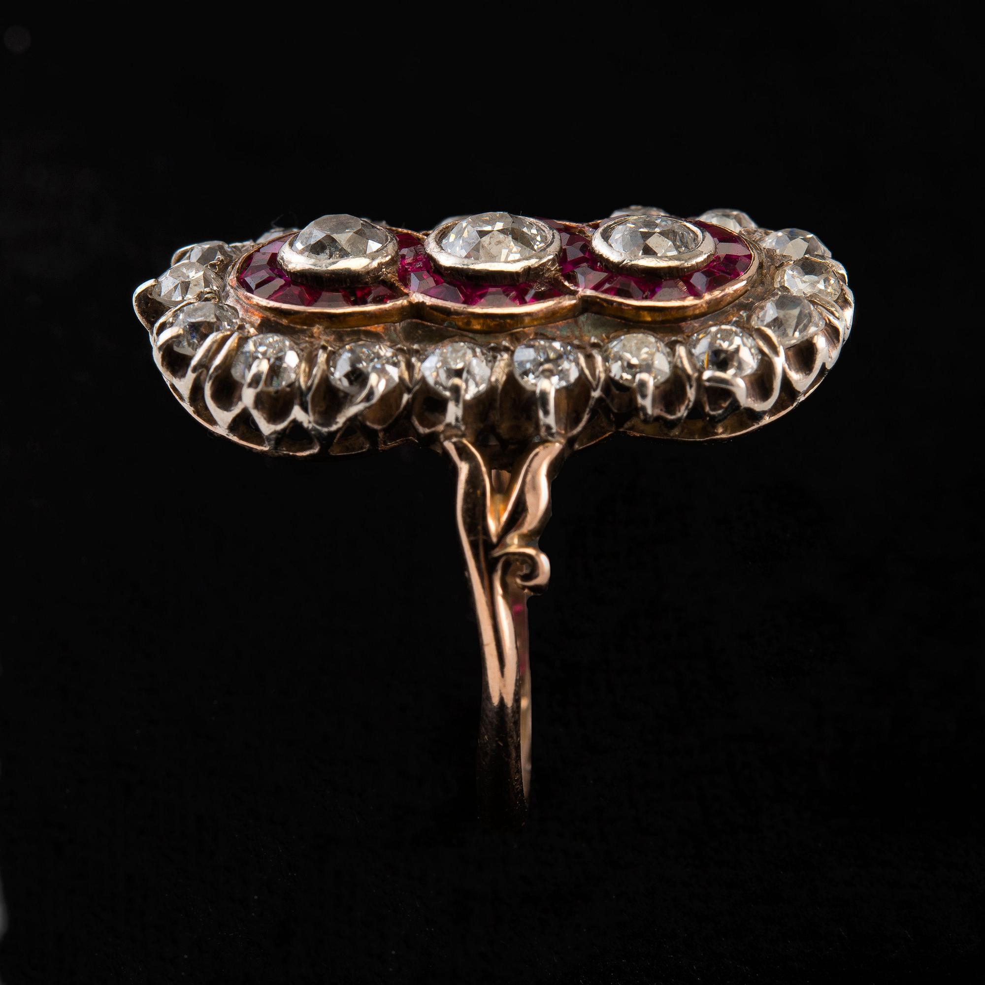 A RING, old cut diamonds c. 2.50 ct. 28 rubies. 14K gold. Likely Russia early 1900 s. Weight 6,3 g.