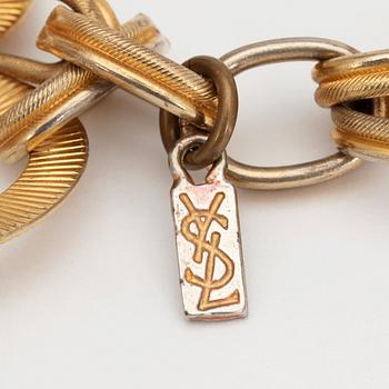 YVES SAINT LAURENT, a gold colored metal chain.