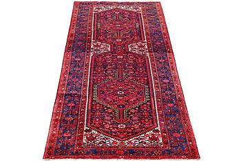 A Hosseinabad carpet, c. 391 x 135 cm.