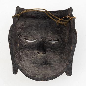 A lacquered wooden mask, 20th century.