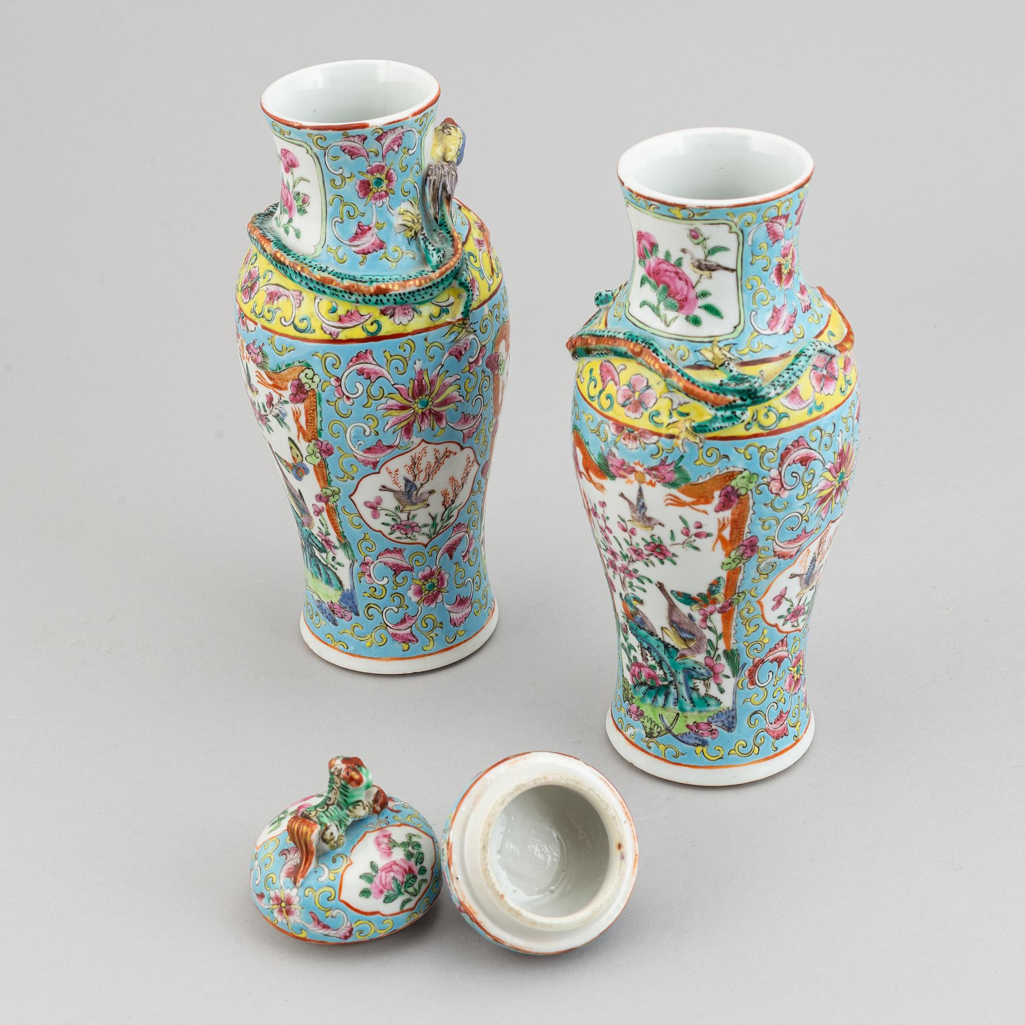 A pair of famille rose canton porcelain vases with covers, Qing dynasty, late 19th century.