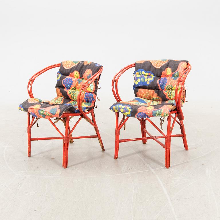 A pair of painted rattan armchairs possibly by Svenskt Tenn.