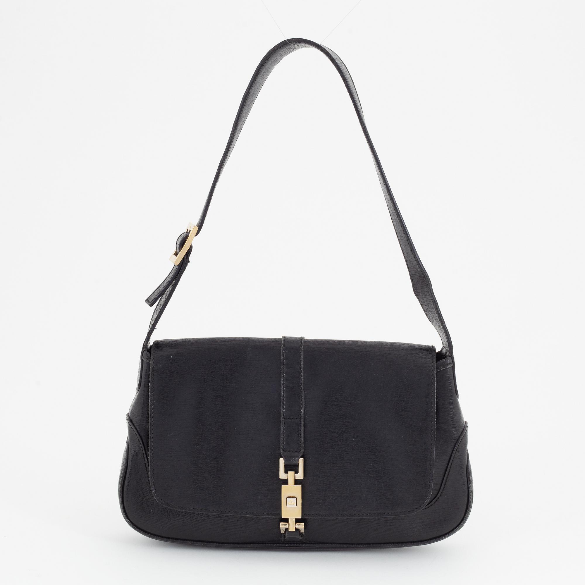 Gucci, a black and gold bag.