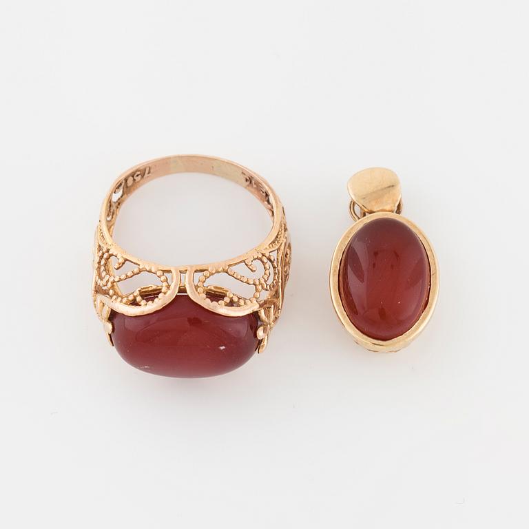 A cabochon cut carnelian ring and brooch.