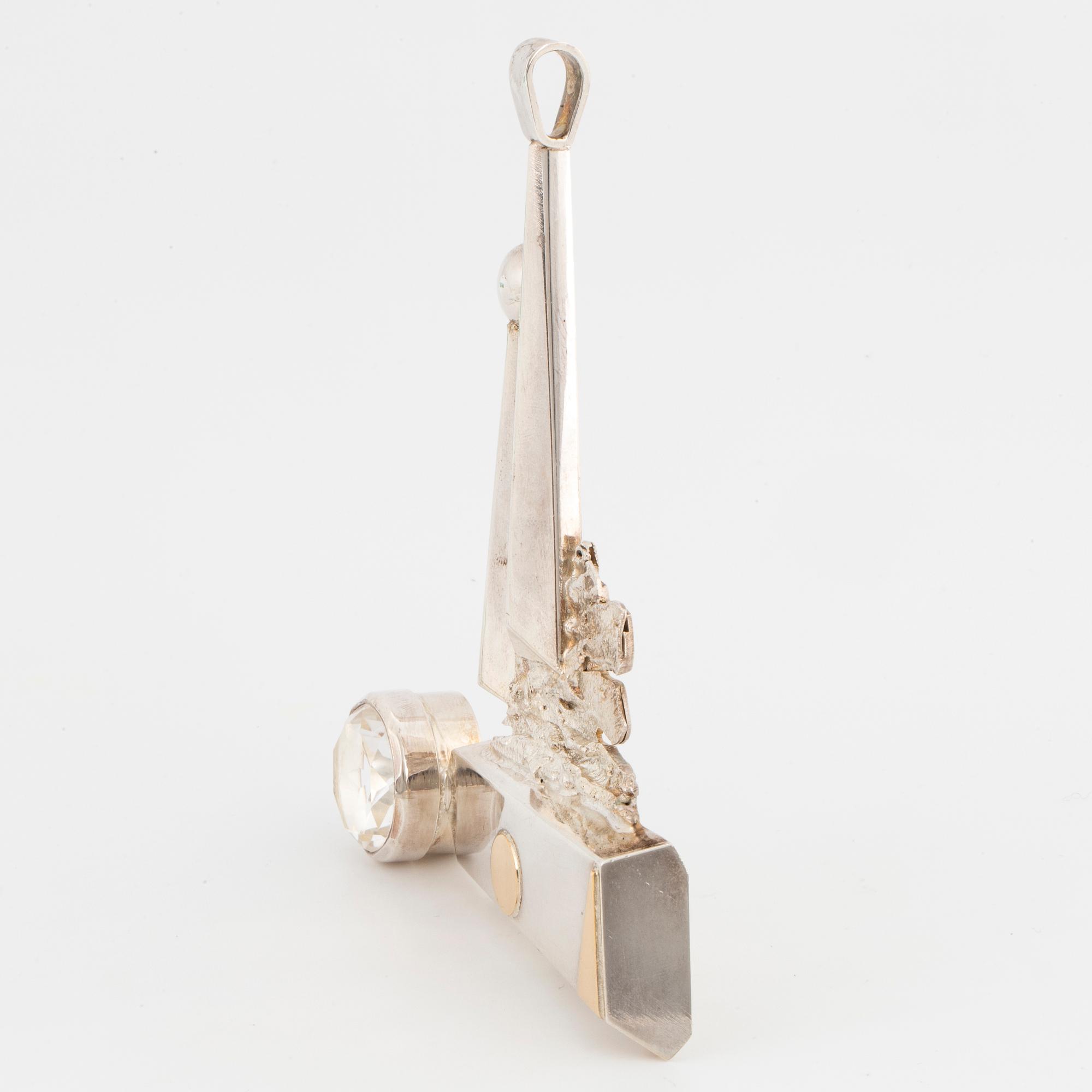 A Rolf Karlsson sterlingsilver + 18K gold and round faceted rock crystal pendant.