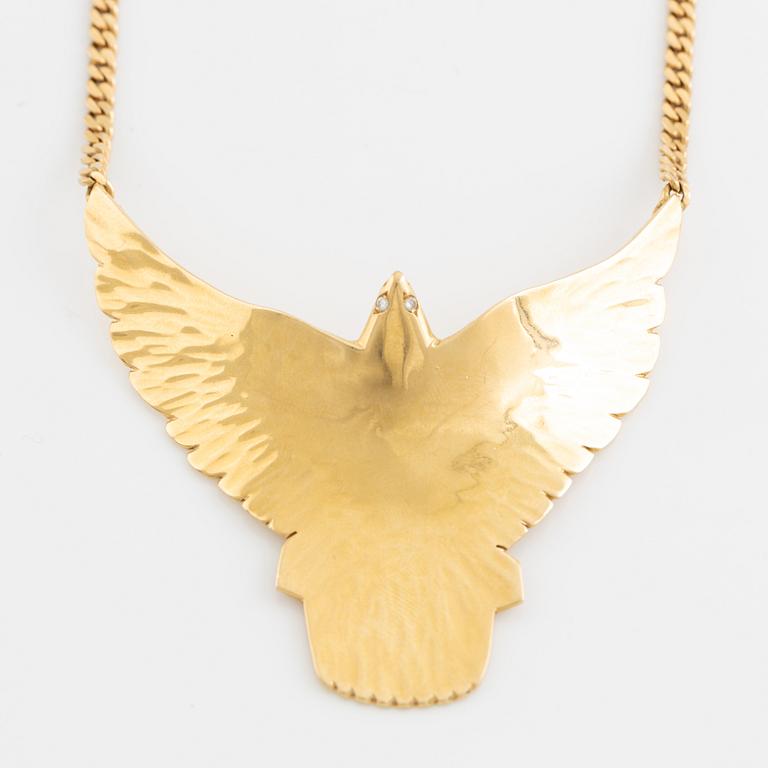 Gold and brilliant cut diamond bird necklace.