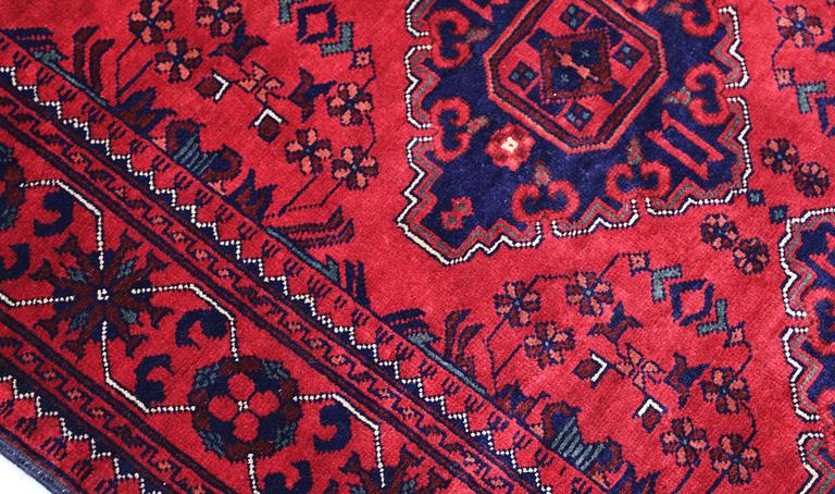 An Afghan runner, approximately 283 x 87 cm.