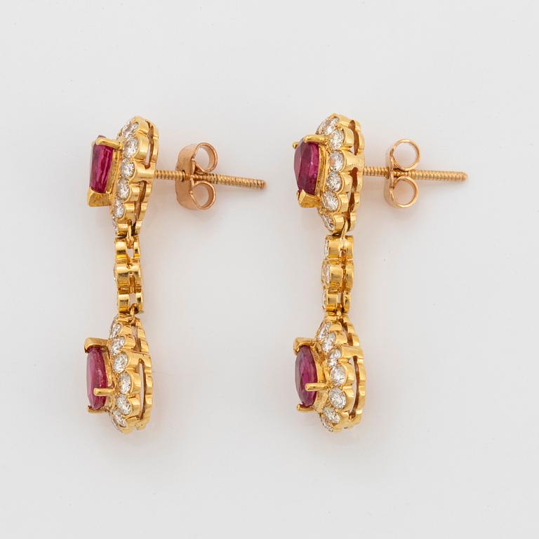 A pair of 18K gold earrings set with faceted rubies and round brilliant-cut diamonds.