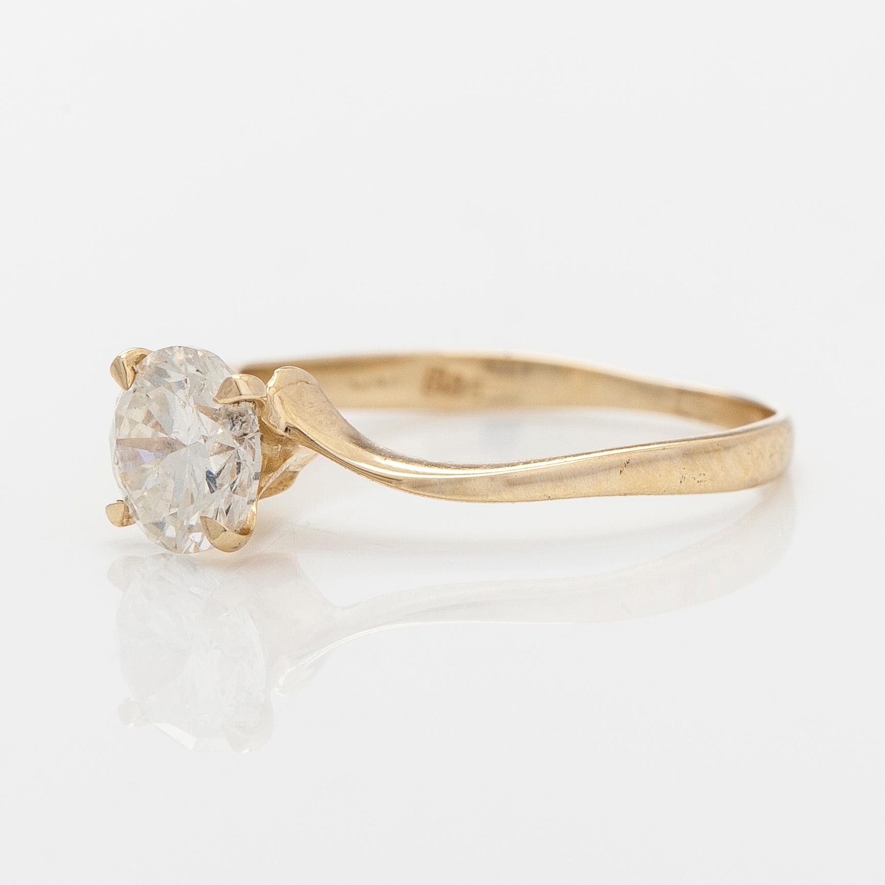 A 14K gold ring with brilliant cut diamond.