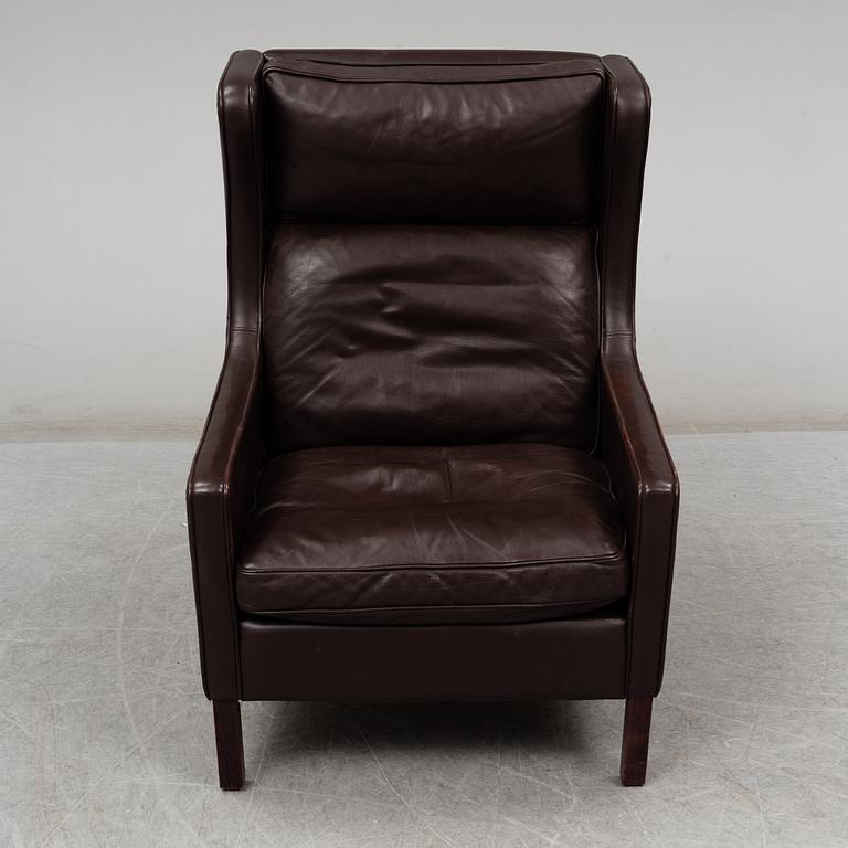 A leather covered 'Lulu' wing-chair from Stouby, Denmark, second half of the 20th Century.