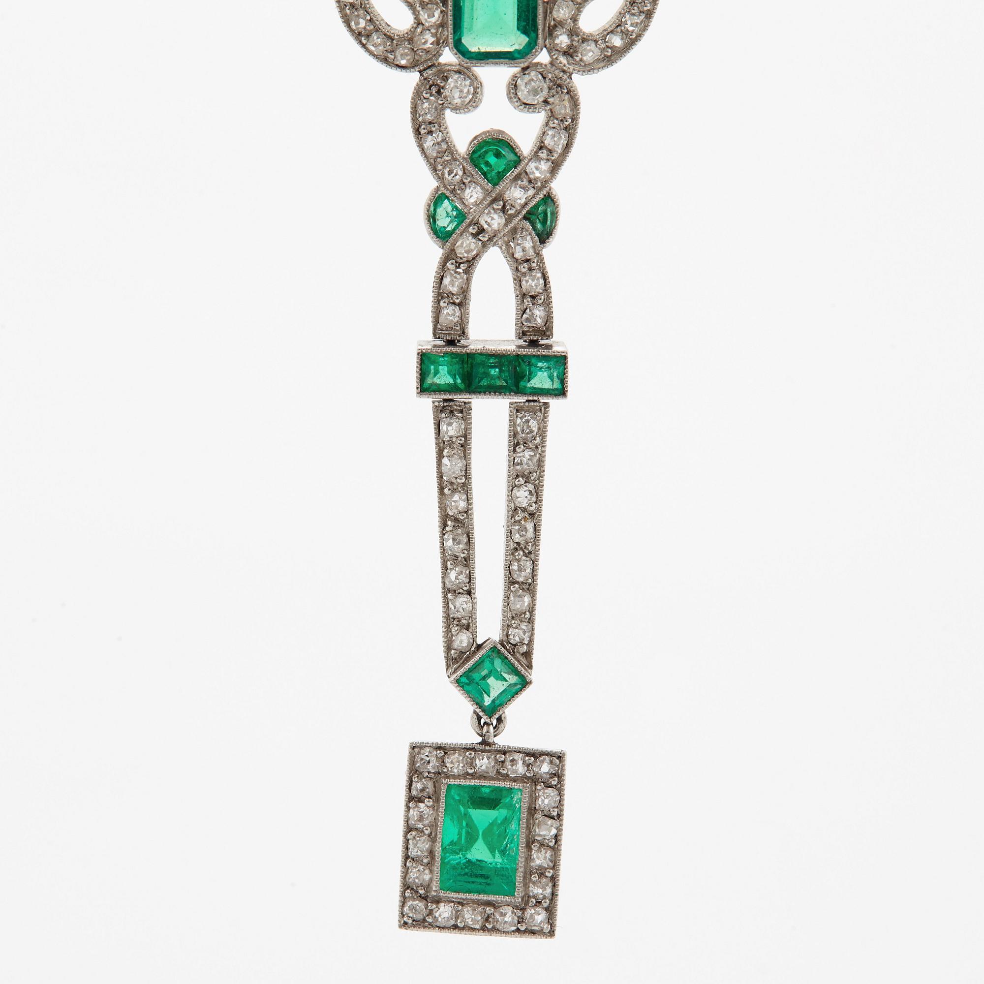 A platinum necklace set with faceted emeralds and old- and eight-cut diamonds.