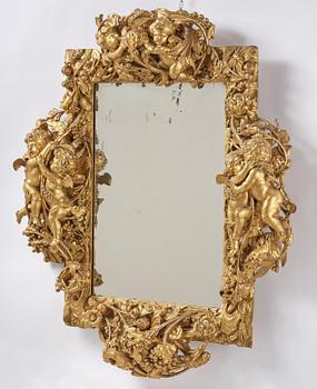 A presumably Dutch Louis XIV carved giltwood frame with mirror glass, in the style of Jean Le Pautre, late 17th century.