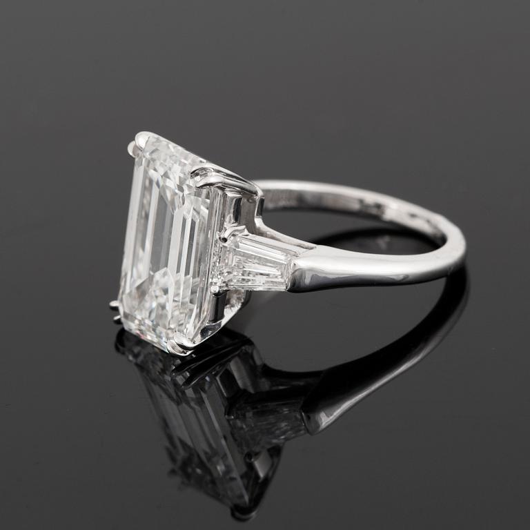 A platinum ring set with an emerald-cut diamond.