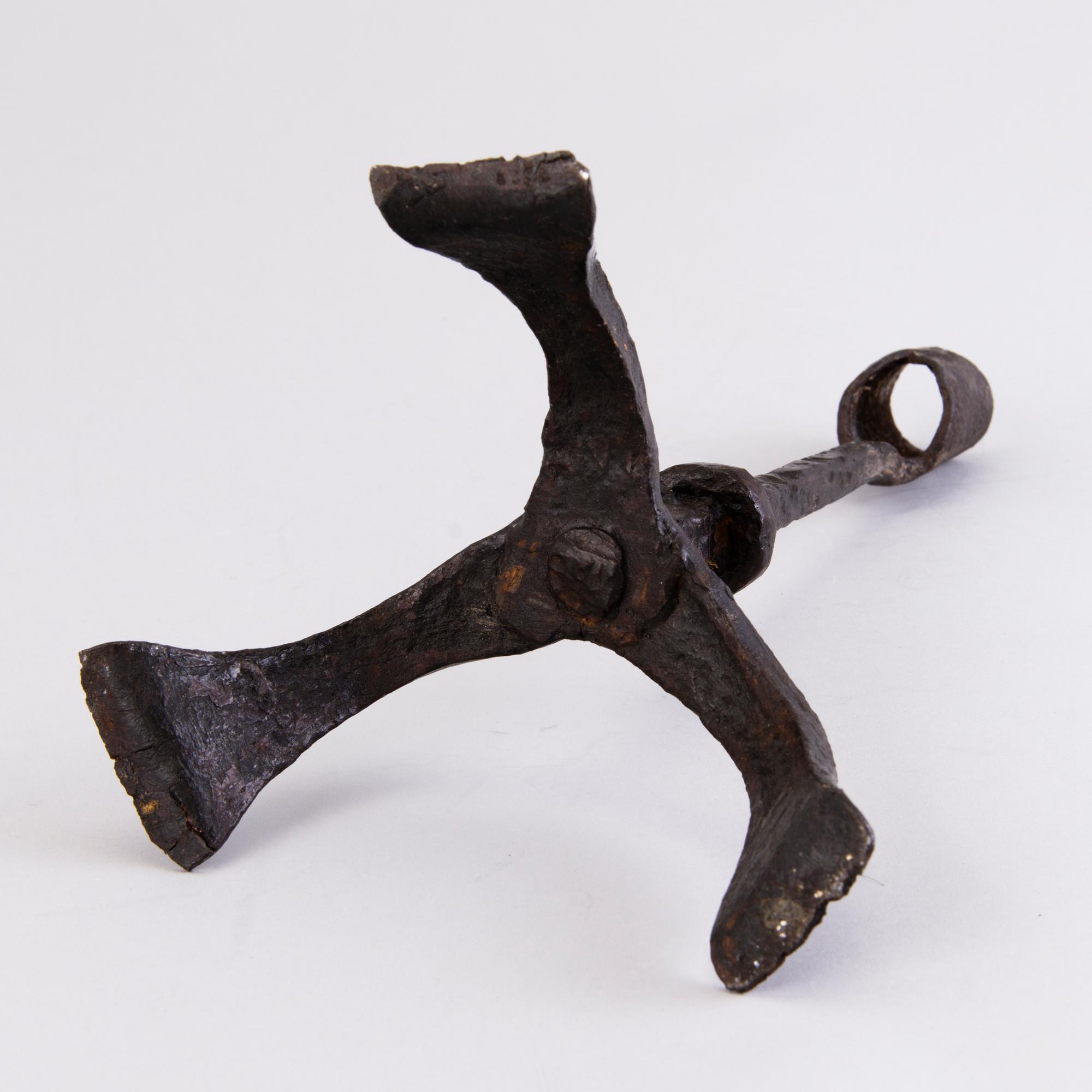 A CANDLESTICK, iron, 18th century or older.