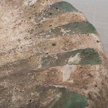 a concrete bird bath from the early 20th century.