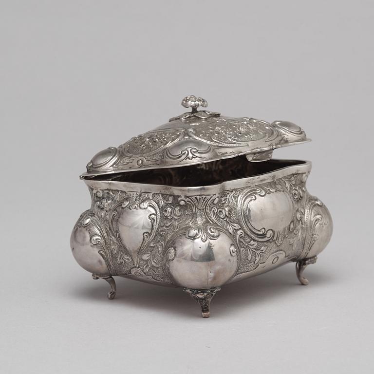 A silver sugar box.