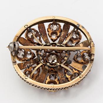 A 12K gold brooch with enamel and old- and rose- cut diamonds.