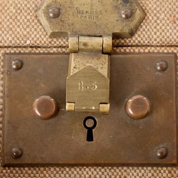 HERMÈS, a linen and leather suitcase, early 20th cent.