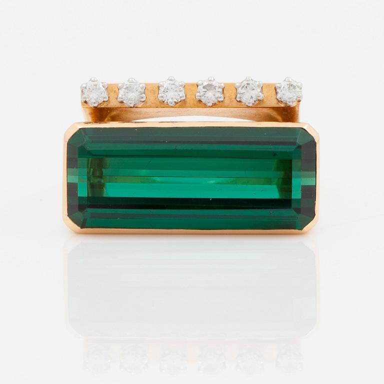 A circa 12.00 ct green tourmaline and brilliant cut diamond ring. Total carat weight of diamonds circa 0.21 ct.