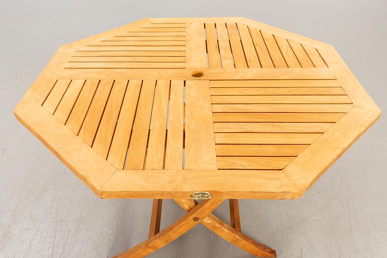 A set of four chairs and a table Royal teak and others, later part of the 20th century.