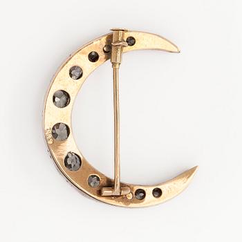 A late 19th century crescent brooch, 14K gold/silver, with old-cut diamonds totalling approximately 1.24 ct.