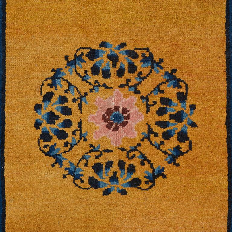 A RUG, an old China, ca 177,5 x 92,5 cm.