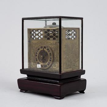 A Japanese brass mantel clock, 19th Century.