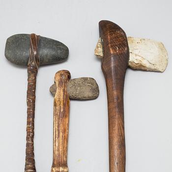 Three stone axes with modern handles.