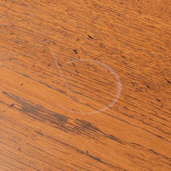 An stained oak dining table with eight chairs.