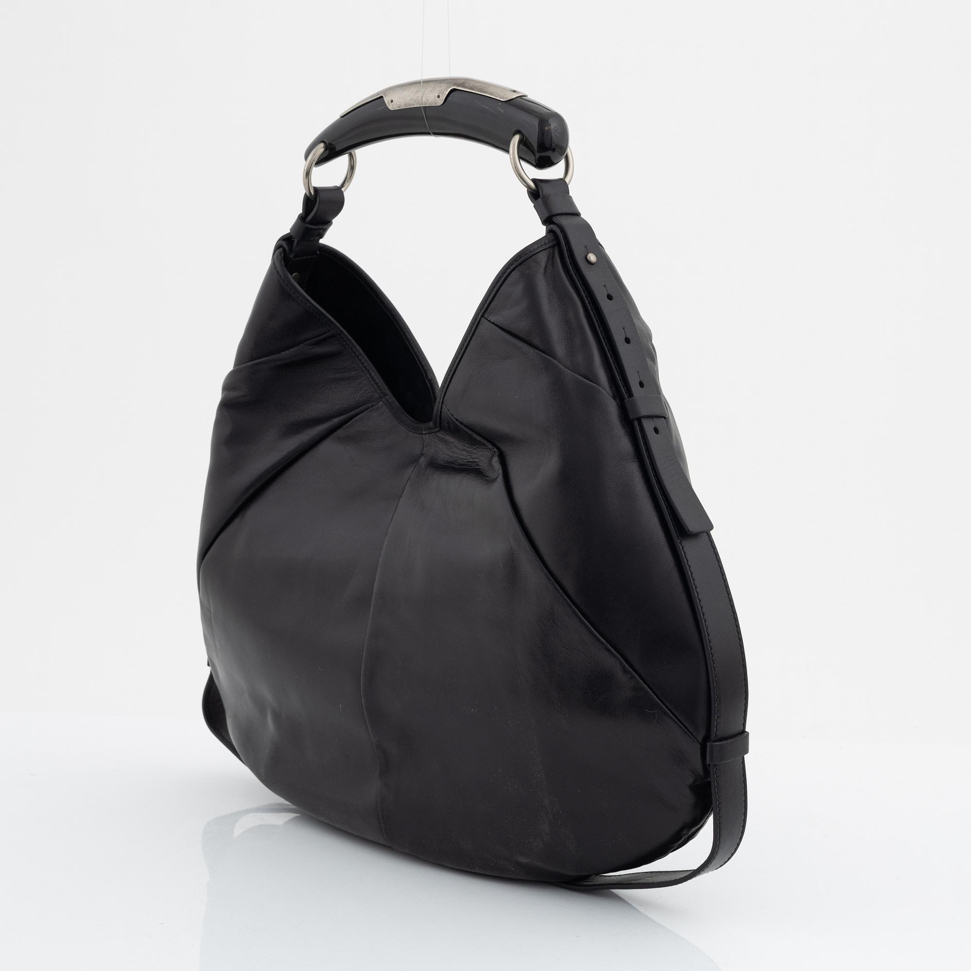 Yves Saint Laurent, a black leather and horn hobo bag.