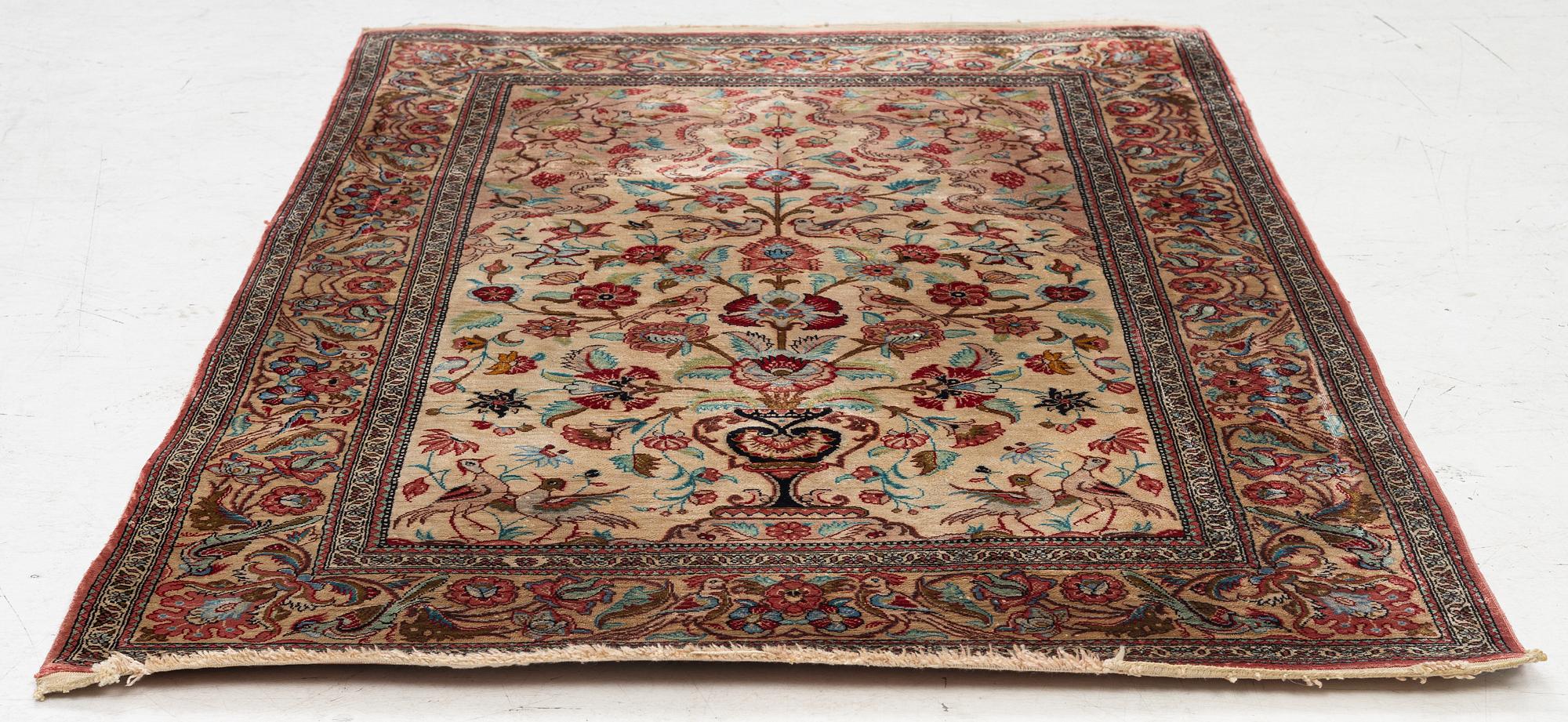 A Qum silk rug, c. 110 x 76 cm.
