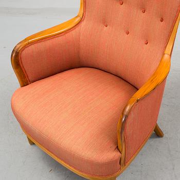 a 20h Century walnut armchair "Advokaten" designed by Carl Malmsten.