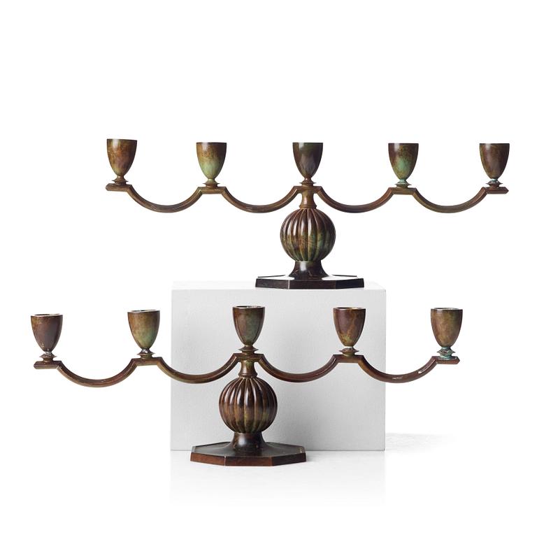 GULDSMEDSAKTIEBOLAGET (GAB), a pair of Swedish Grace patinated bronze candelabra, Stockholm 1930's.