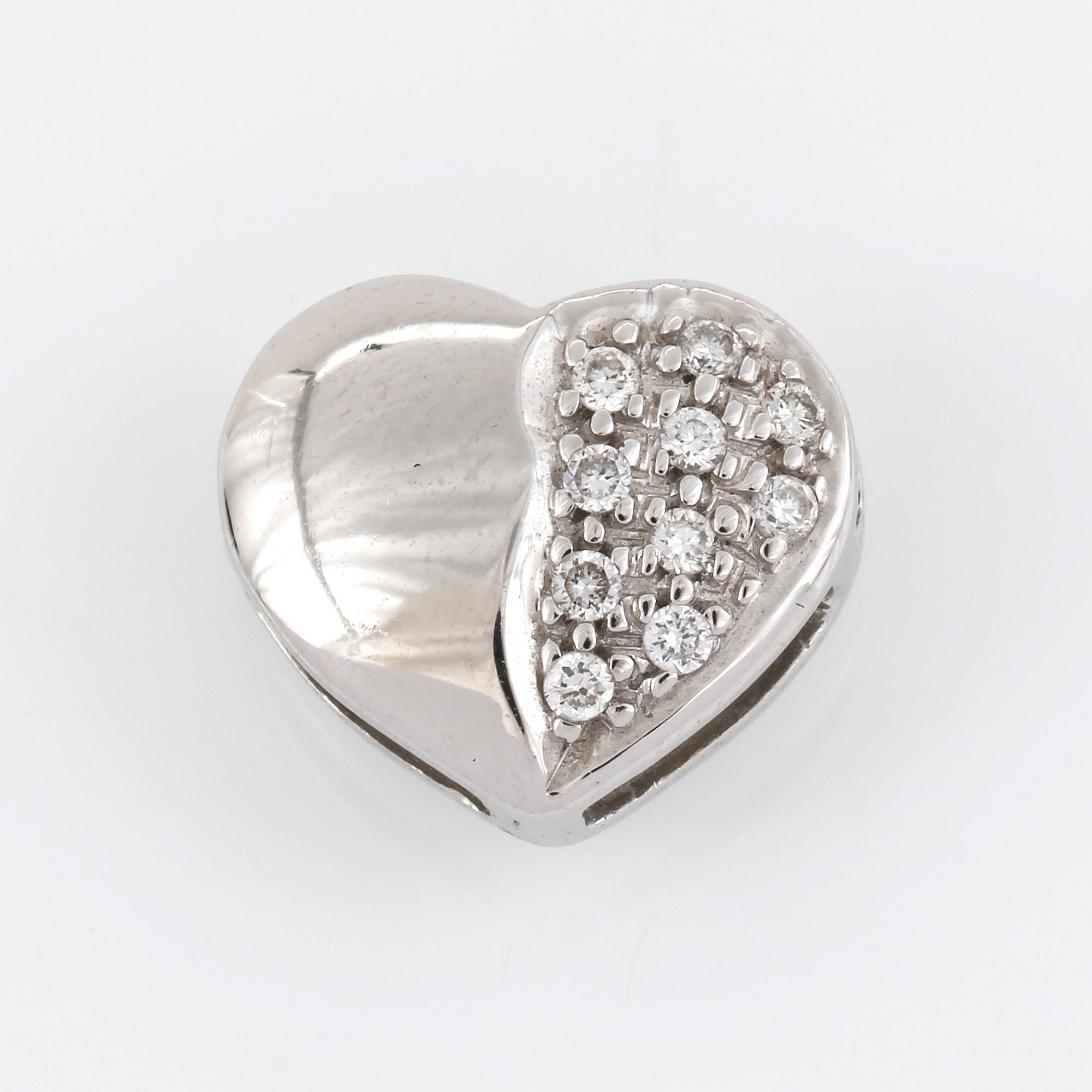 HÄNGE, vändbart i 18K vitguld, hjärta med sidledes öppning och diamanter ca 0.02ct.