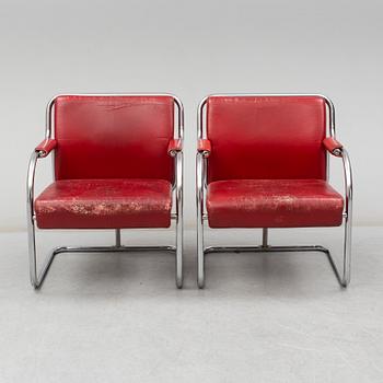 A pair of 1920s armchairs.