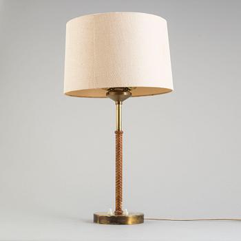 A brass and leather table light from Nordiska Kompaniet, mid 20th Century.