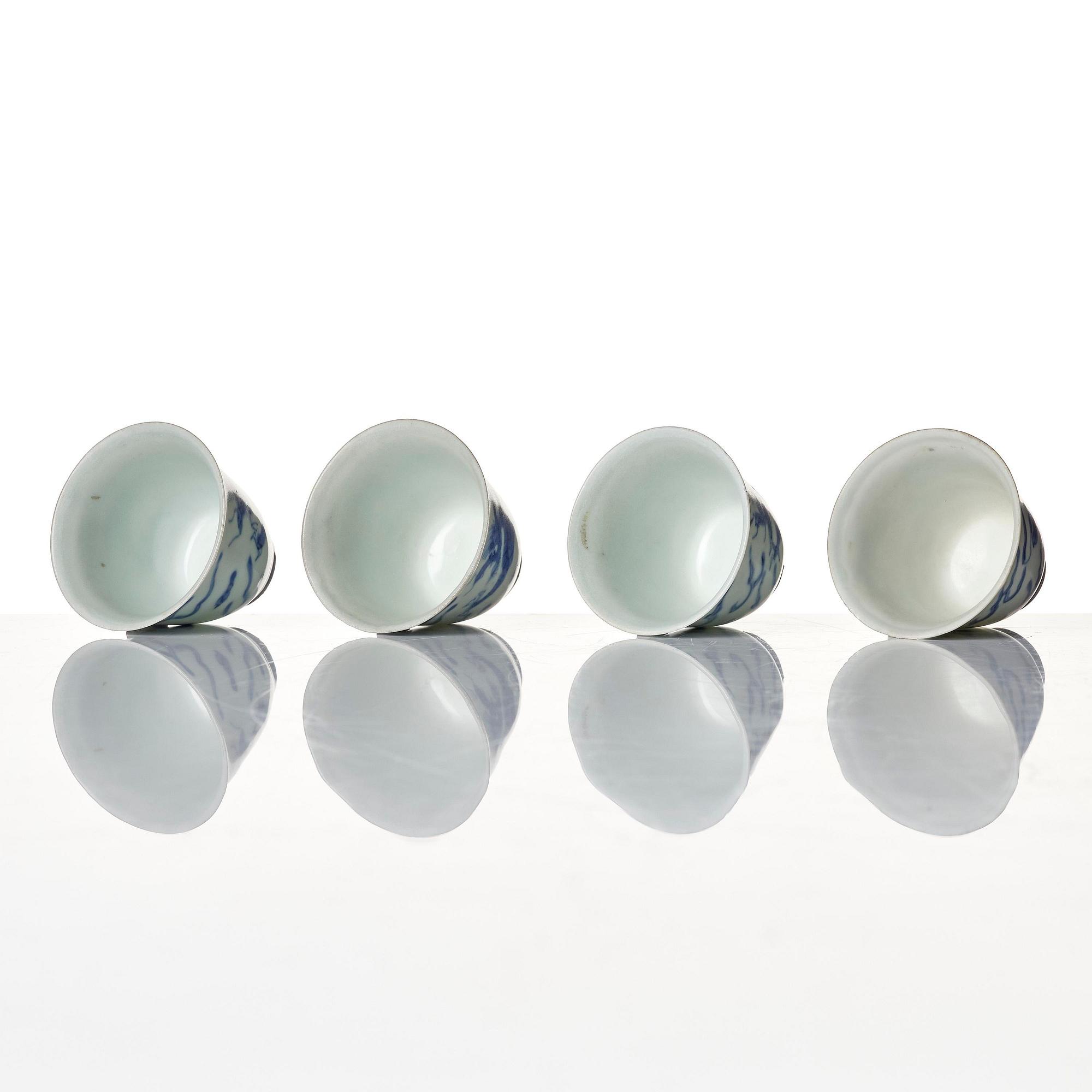 A set of four blue and white dragon wine cups, 'Hatcher Cargo', 17th century.
