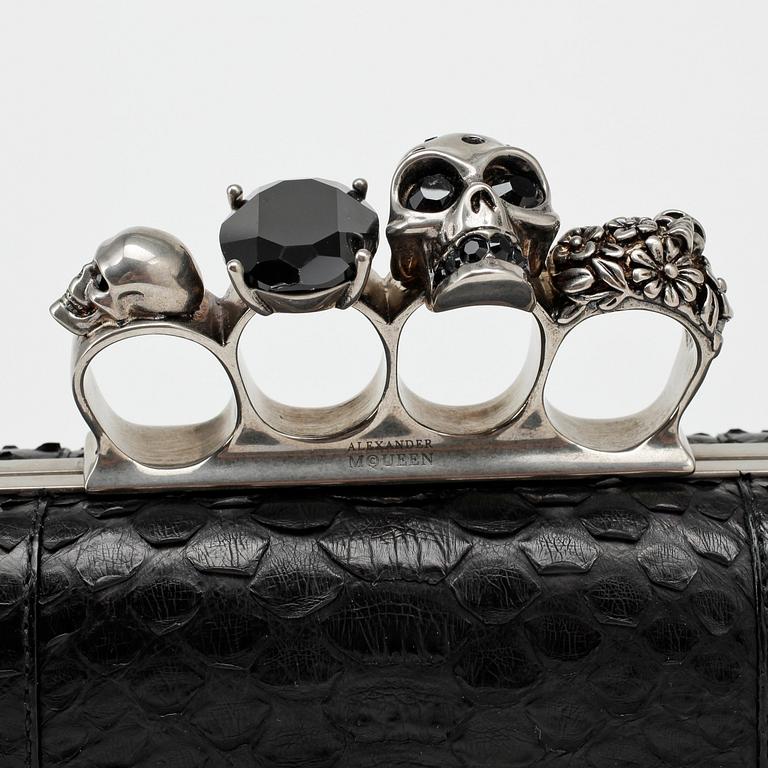 ALEXANDER MCQUEEN, a black python "Knucklebox Clutch".