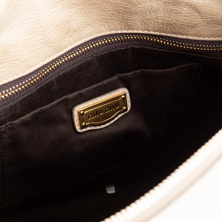 Miu Miu, a leather handbag.