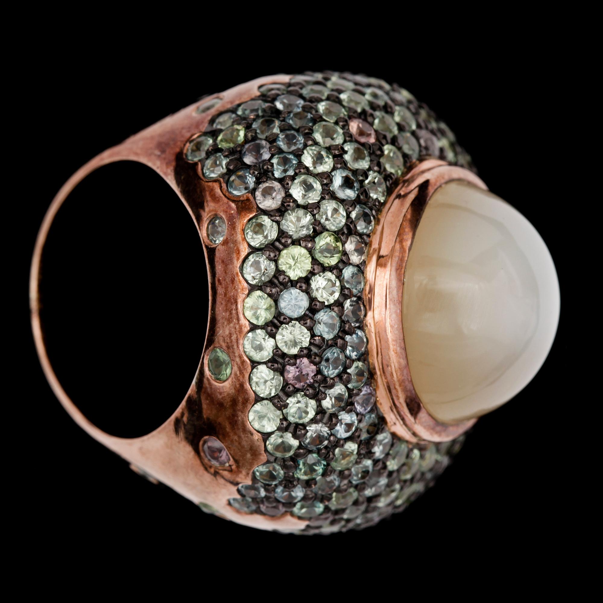 A cabochon cut moonstone and sapphire ring.