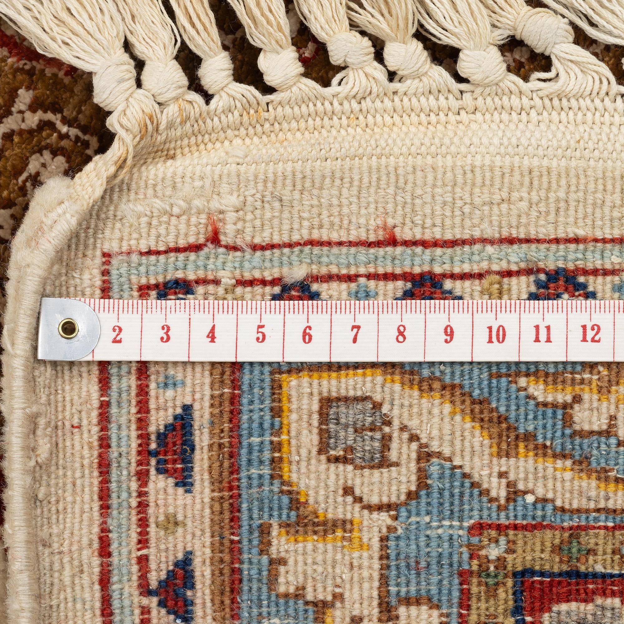 A Tabriz carpet, part silk, Northwest Persia (Iran), c. 323 x 246 cm.