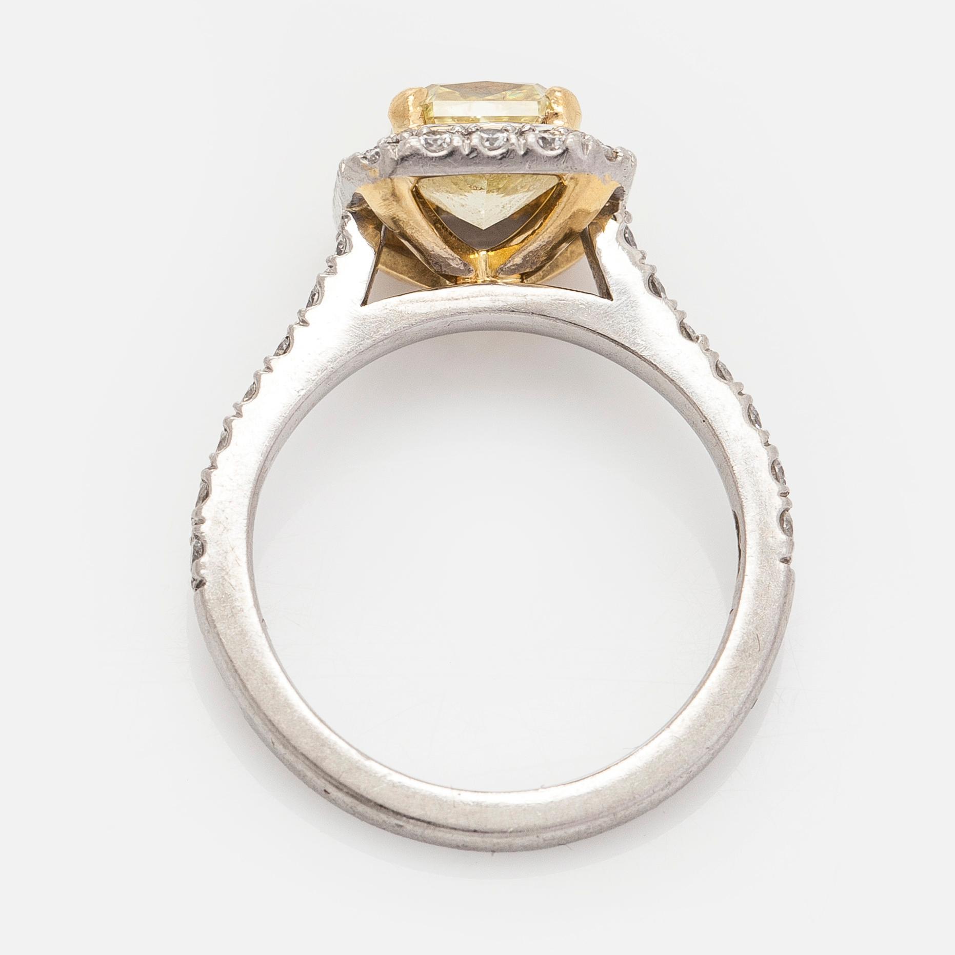 platinum ring with yellow radiant-cut diamond and brilliant cut diamonds.