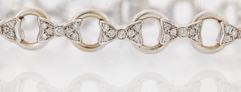 An 18K white gold bracelet set with round brilliant-cut diamonds.